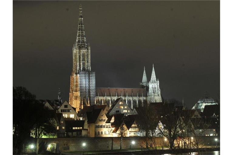 Das Ulmer Münster leuchtet in der Nacht. Foto: Stefan Puchner/dpa/Archivbild