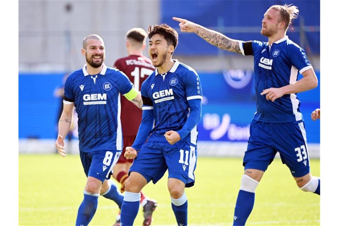 DFB-Pokal: KSC kämpft um Einzug ins Halbfinale Die Karlsruher, (l-r) Jerome Gondorf, Kyoung-rok Choi und Philipp Hofmann, jubeln. Foto: Uli Deck/dpa