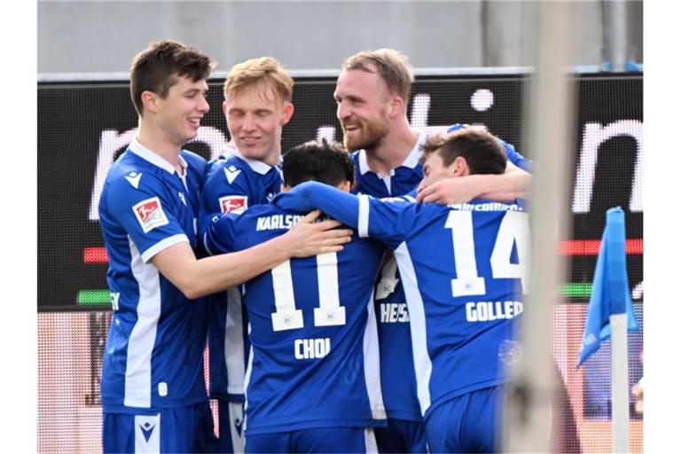 Die Karlsruher Mannschaft bejubelt den Treffer zum 3:1 durch Philipp Hofmann (M). Foto: Uli Deck/dpa