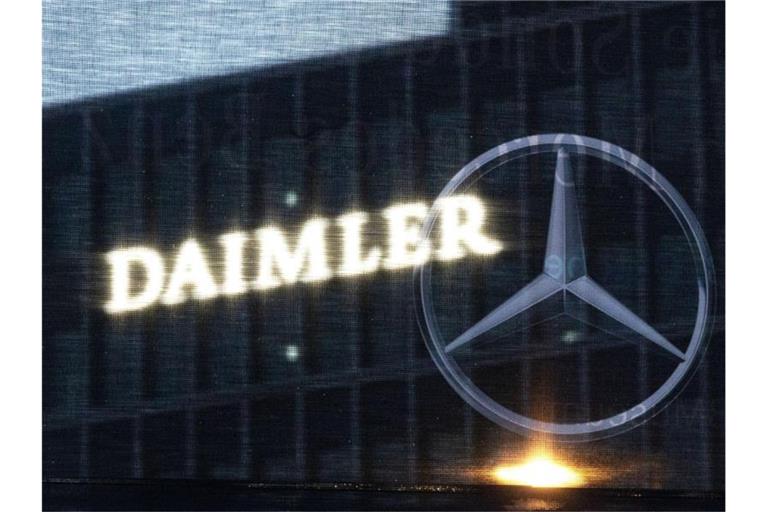 Die Zentrale der Daimler AG ist durch eine Flagge zu sehen, auf der der Mercedes-Stern abgebildet ist. Foto: Marijan Murat/dpa/Archivbild