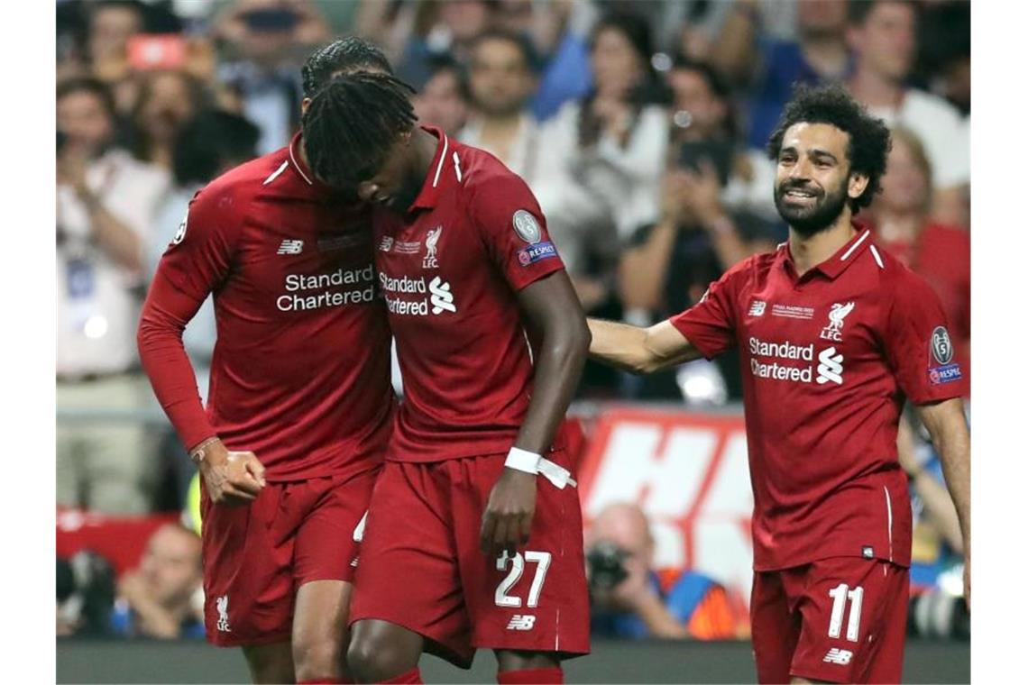 Klopp führt Liverpool gegen Tottenham auf Europas Thron Divock Origi (M) wird für sein Tor zum 2:0 von van Dijk und Salah (r) gefeiert. Foto: Jan Woitas