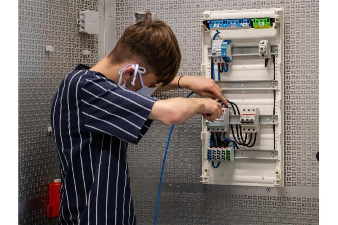 Ein Auszubildender arbeitet in einer Werkstatt. Foto: Christoph Schmidt/dpa/Symbolbild