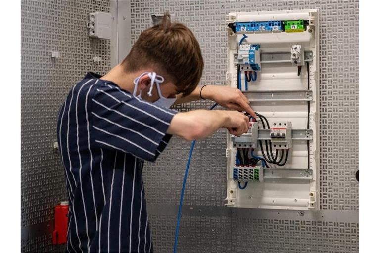 Ein Auszubildender arbeitet in einer Werkstatt. Foto: Christoph Schmidt/dpa/Symbolbild