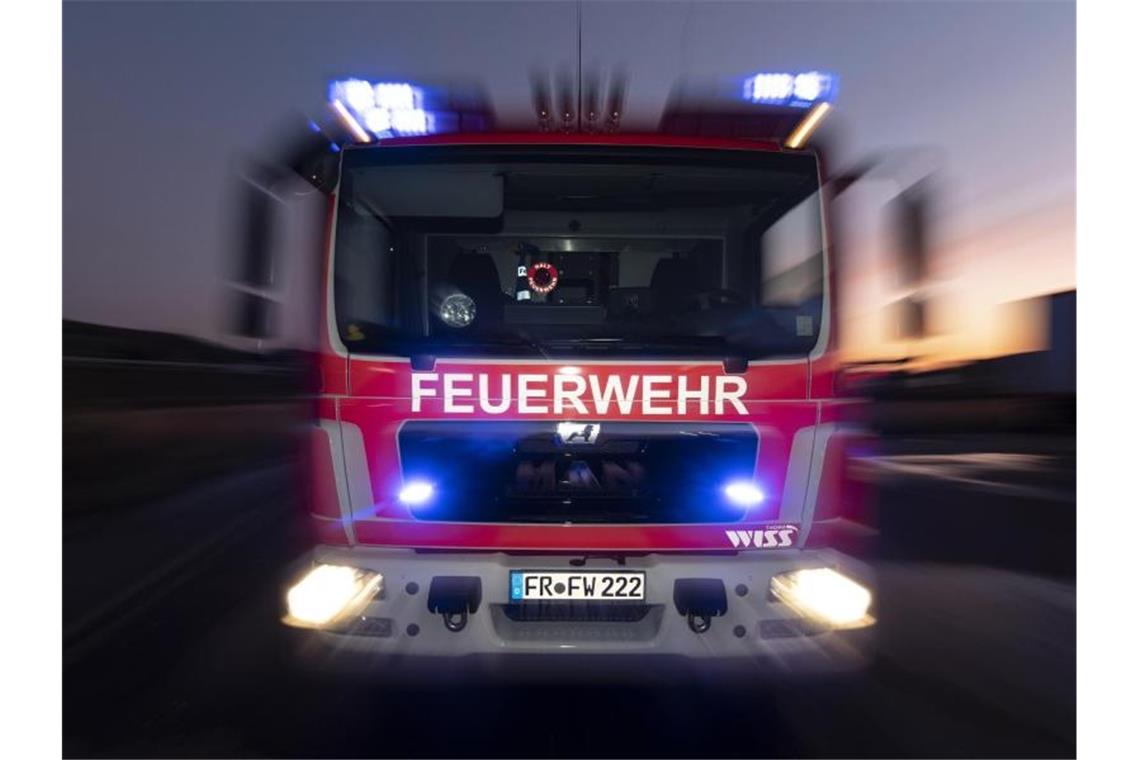 Feuer auf Schulgelände: Verdacht auf Brandstiftung Ein Feuerwehrfahrzeug steht mit eingeschaltetem Blaulicht auf einer Straße. Foto: Patrick Seeger/dpa/Symbolbild