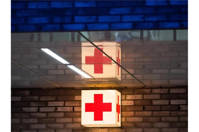 Ein Leuchtkasten mit einem roten Kreuz hängt vor der Notaufnahme eines Krankenhauses. Foto: Julian Stratenschulte/dpa/Symbolbild