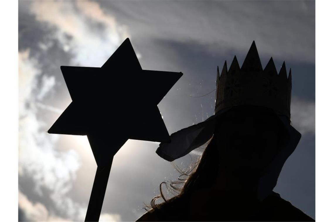 Ein Sternsinger hält einen Sternstab in der Hand. Foto: Patrick Seeger/dpa/Symbolbild