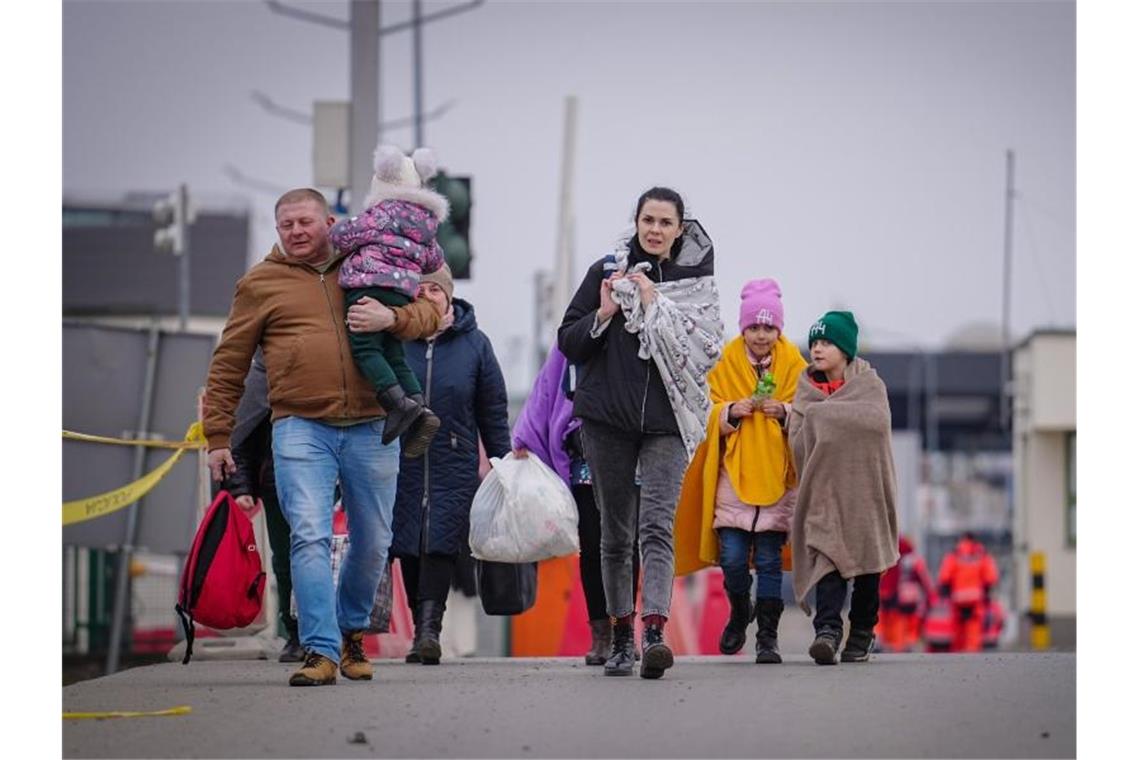 In Polen bereits 500.000 Flüchtlinge eingetroffen Eine Familie passiert die ukrainisch-polnische Grenze in Medyka. Foto: Kay Nietfeld/dpa