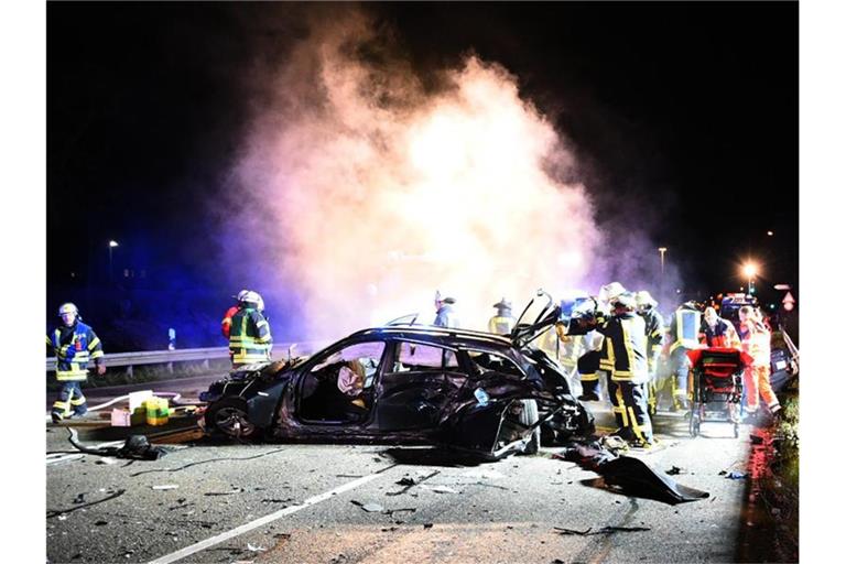 Einsatzkräfte der Polizei, Feuerwehr und Rettungsdienste stehen bei einer Unfallstelle auf der Mannheimer Straße. Foto: Rene Priebe/dpa