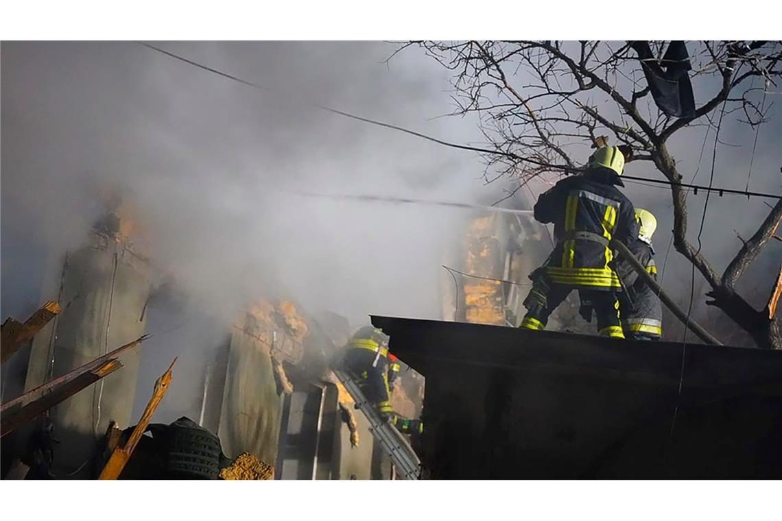 Feuerwehrleute arbeiten an einem brennenden Gebäude nach einem russischen Angriff in Odessa.