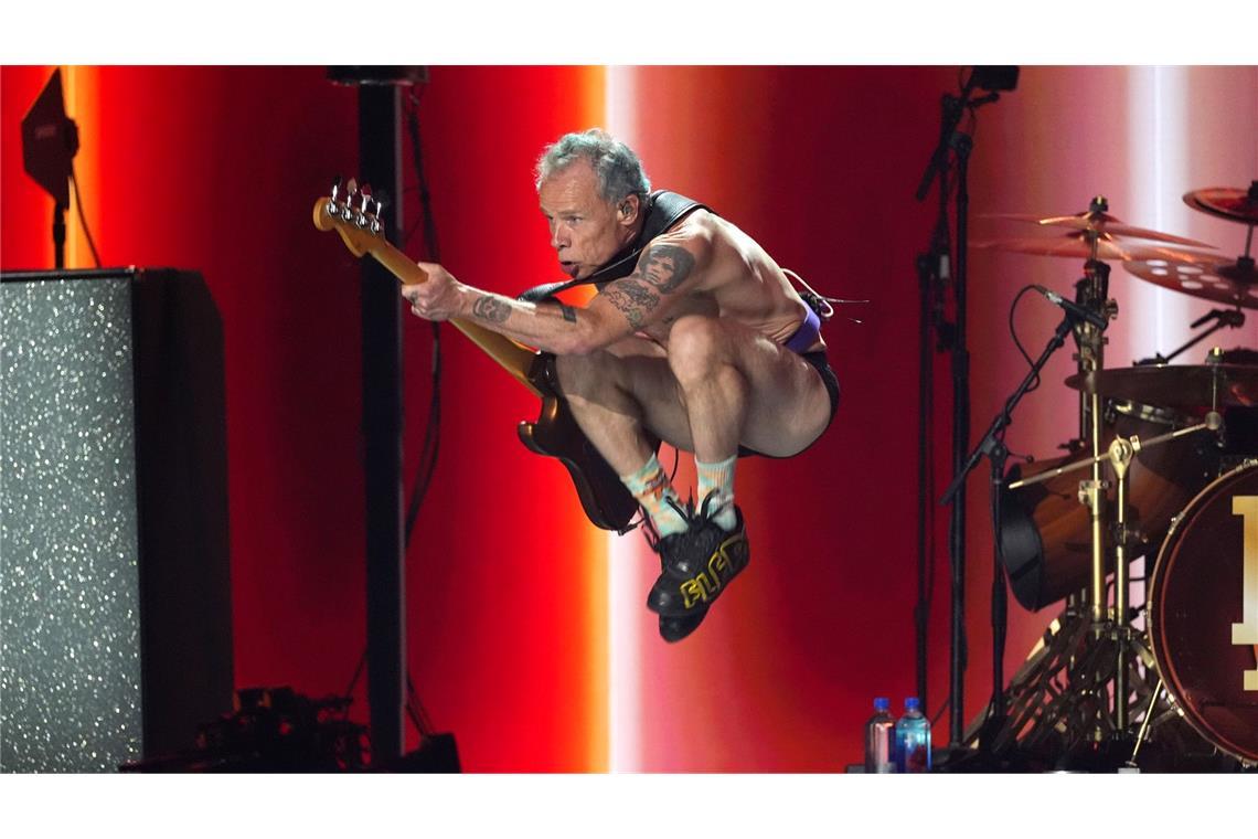 Flea von den Red Hot Chili Peppers macht Luftsprünge.