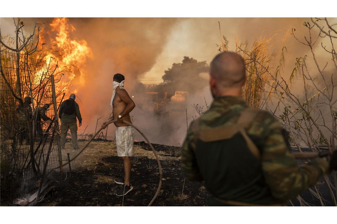 Freiwillige löschen einen Waldbrand in Ano Patima in der Nähe von Penteli in der Region Nord-Athen.