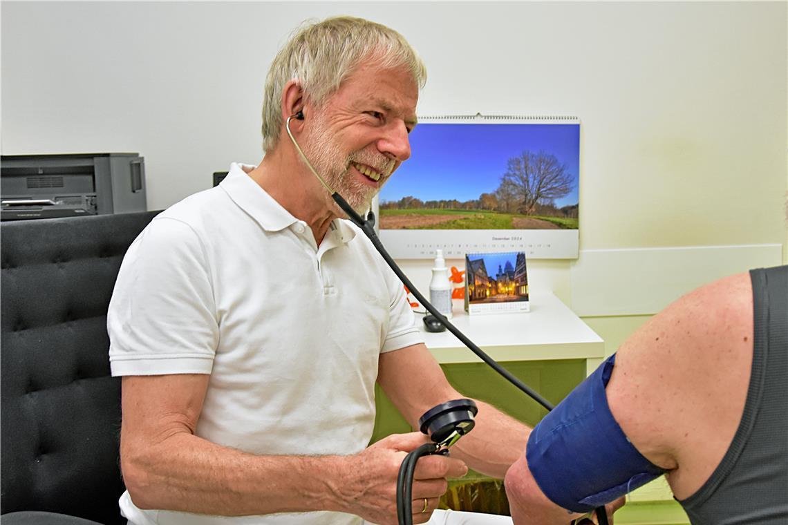 Günther Ulfert misst den Blutdruck eines Patienten in der Arztpraxis, die er in Backnang mit seiner Frau Ute Ulfert betreibt. Foto: Tobias Sellmaier