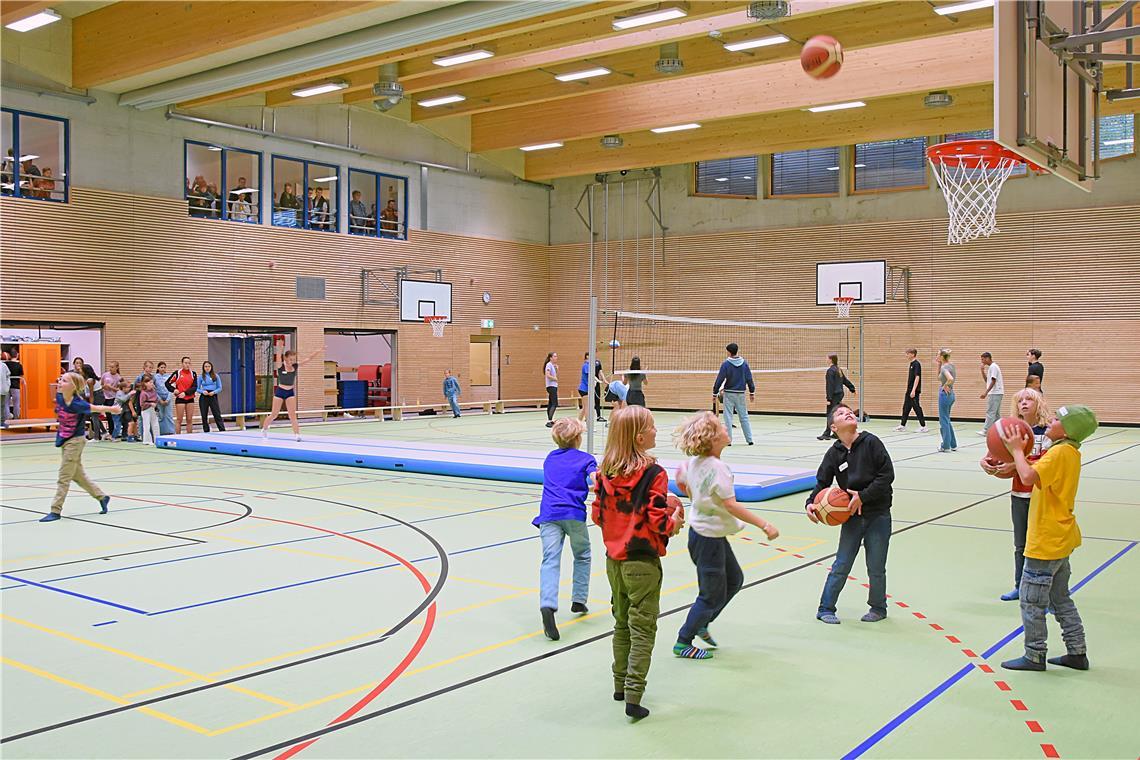 Kinder toben sich in der Sporthalle aus, die in das neue Gebäude integriert ist.