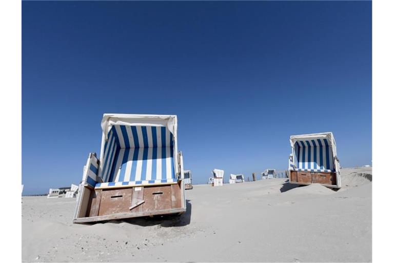 Leere Strandkörbe am Nordseestrand auf Eiderstedt in Schleswig-Holstein. Foto: Carsten Rehder/dpa