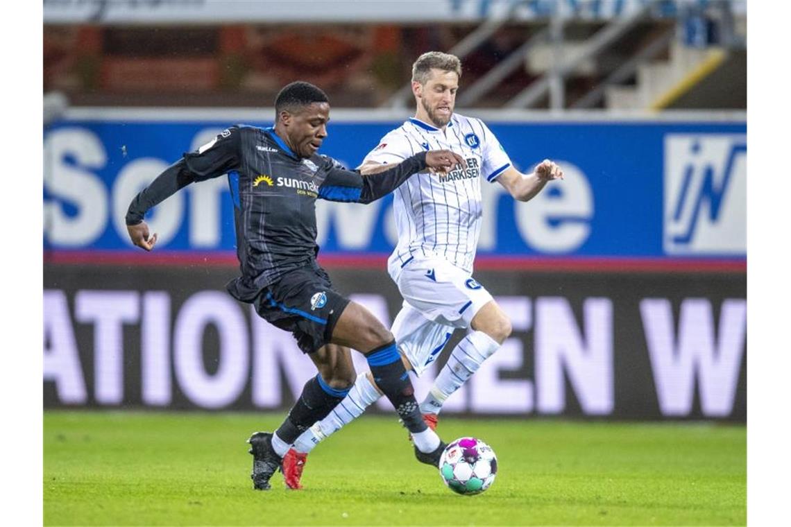 KSC verpasst nach 2:2 in Paderborn wichtige Punkte Paderborns Frederic Ananou und Karlsruhes Marc Lorenz (l-r.) kämpfen um den Ball. Foto: David Inderlied/dpa