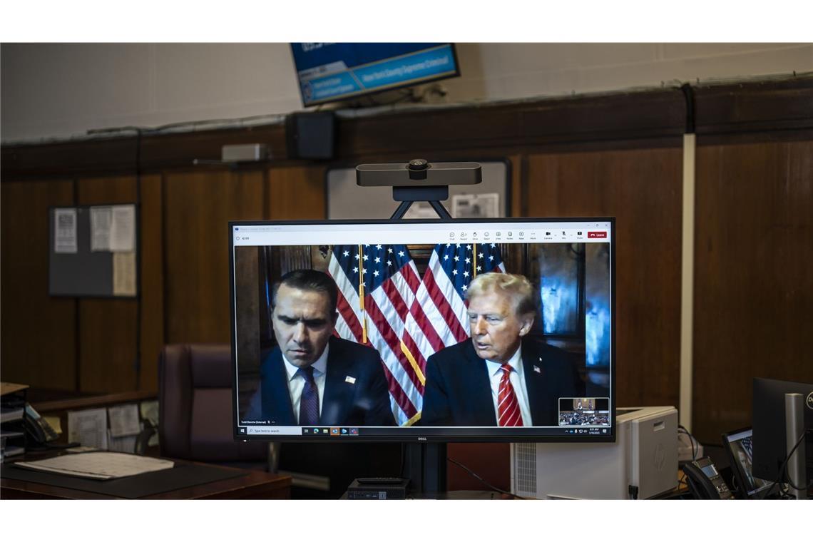 Rechtsanwalt Todd Blanche und der designierte US-Präsident Donald Trump, sind auf einem Fernsehbildschirm zu sehen.