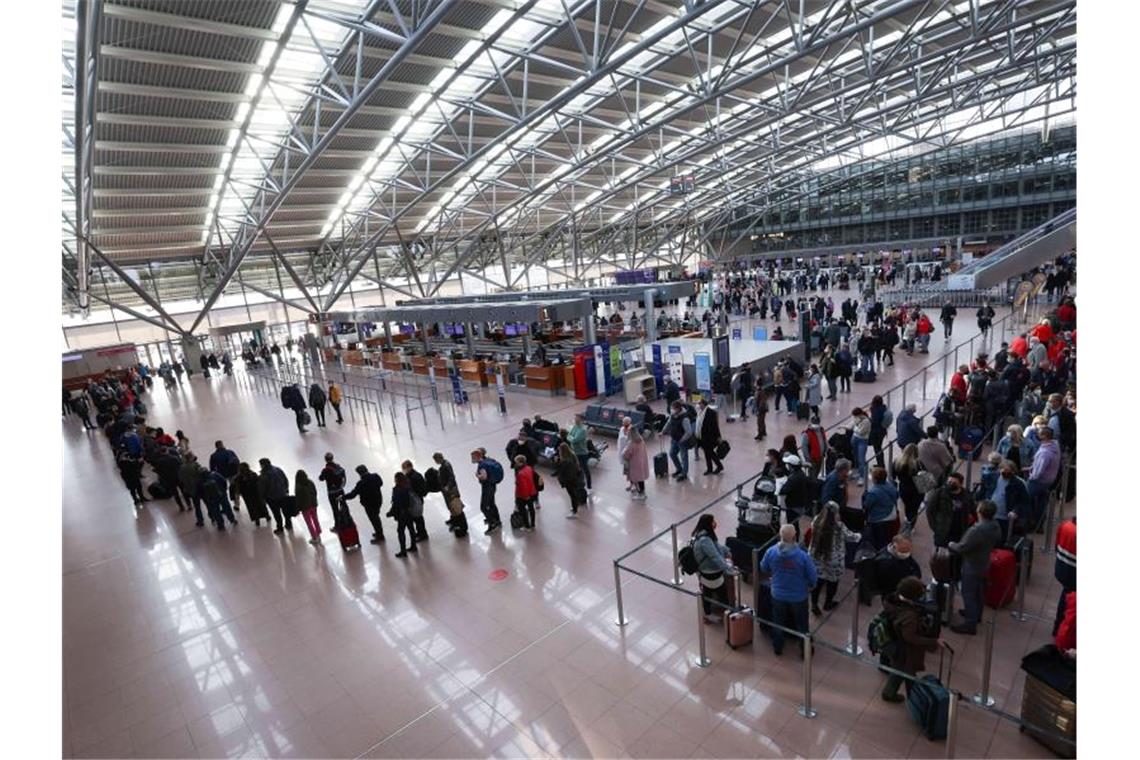 Flughäfen: Verdi-Warnstreik traf 102.000 Passagiere Reisende stehen in langen Schlangen vor dem Check-In (r) und quer durch das Terminal 1 vor der Sicherheitskontrolle im Flughafen Hamburg. Foto: Christian Charisius/dpa