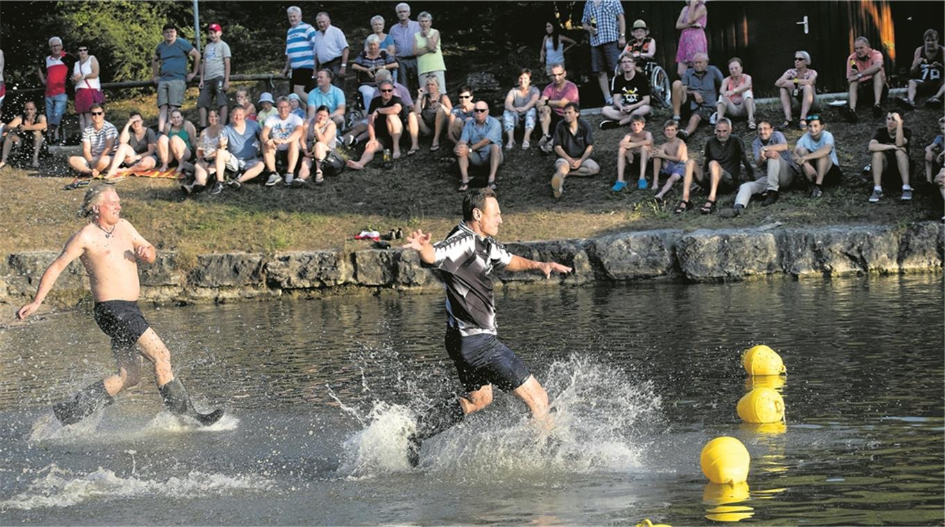 Spaß im Waldsee: Die Aufgabe bestand darin, Gummistiefel mit Wasser zu füllen und dann gekonnt in Becher auszuleeren. Fotos: J. Fiedler