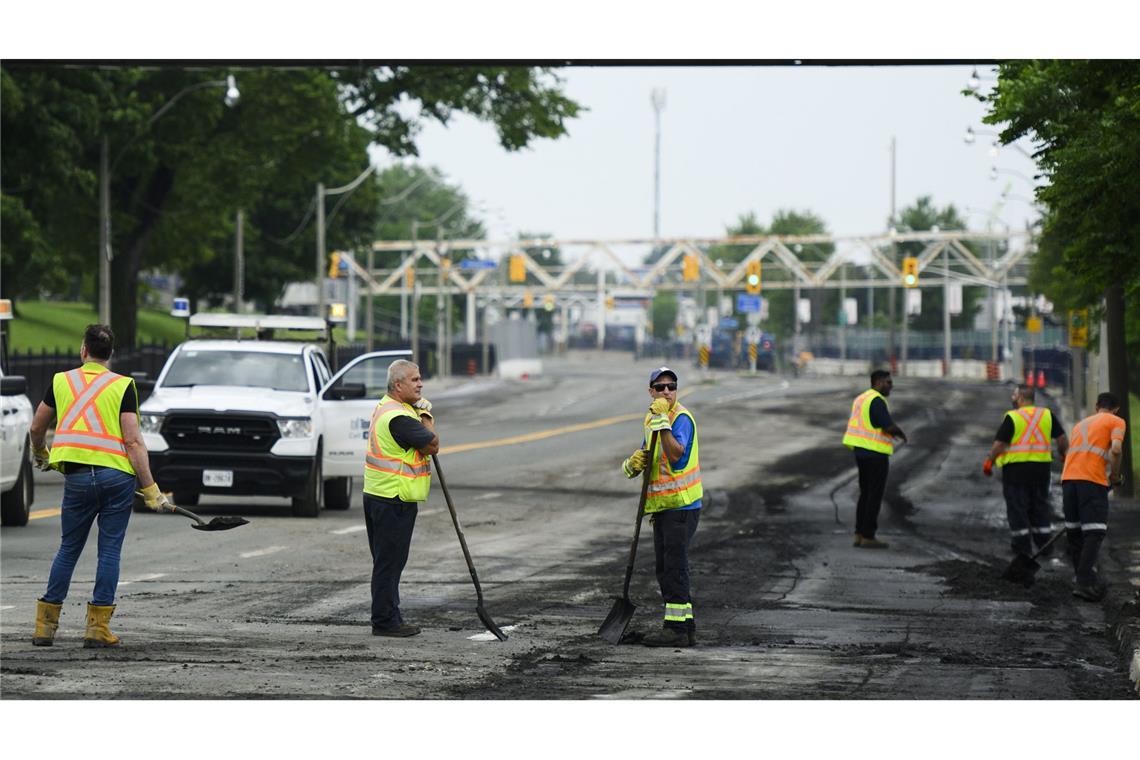 Städtische Mitarbeiter beseitigen in Toronto  Trümmer, nachdem starker Regen zu Überschwemmungen geführt hat.