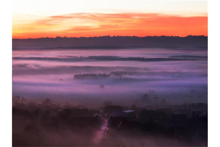 Über Oberschwaben liegt kurz vor Sonnenaufgang eine dichte Nebeldecke. Foto: Thomas Warnack/dpa