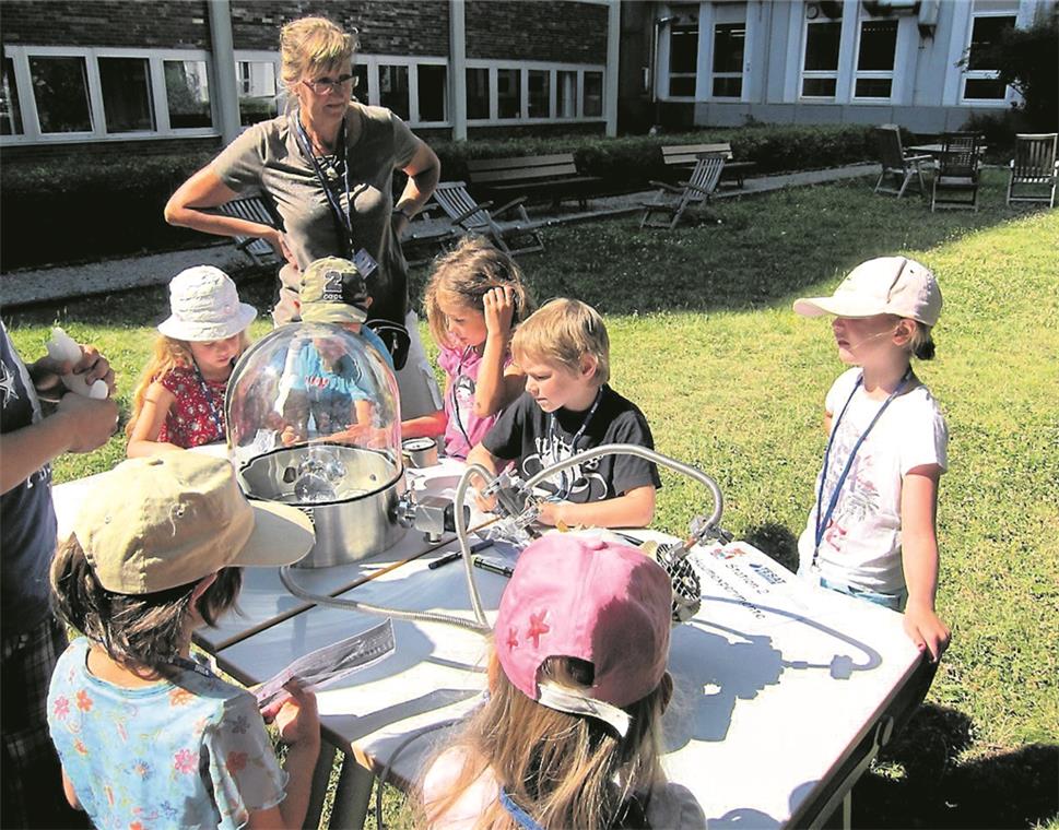 Die Kinderuni Plus geht neue Wege Versuch zum Thema Vakuum/Schwerelosigkeit bei Tesat-Spacecom: Das können bald auch die Kinderforscher erleben. Fotos: Tesat (2), A. Becher(1)