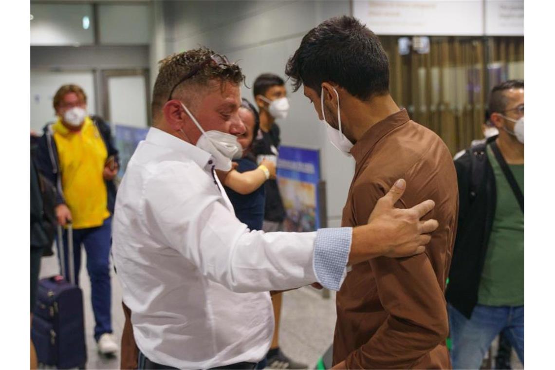 100 Millionen Euro für Flüchtlinge - Hubschrauber nach Kabul Von Kabul nach Frankfurt: Ein Mann wird auf dem Flughafen von seinem Schwiegervater begrüßt. Foto: Frank Rumpenhorst/dpa